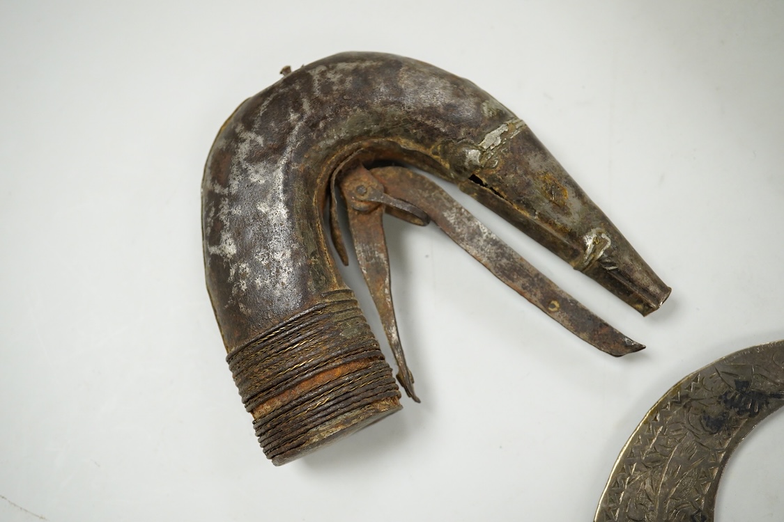 A niello work belt buckle, 21cm wide, an Arab white metal cloak brooch and a powder flask